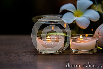 Thai spa composition treatments aroma therapy with candles and Plumeria flowers on wooden table Stock Photo