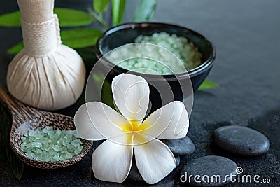 Thai spa composition treatments aroma therapy with candles and Plumeria flowers on wooden table close up. Stock Photo