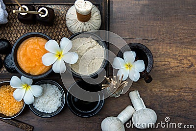 Thai spa composition treatments aroma therapy with candles and Plumeria flowers on wooden table close up. Stock Photo