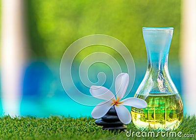 Thai Spa massage with rock spa and aroma oil with Plumeria flowers near swimming pool Stock Photo