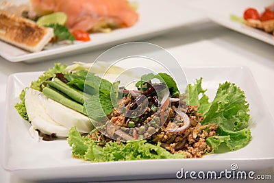 Thai Spicy minced meat salad with beans and chili Stock Photo