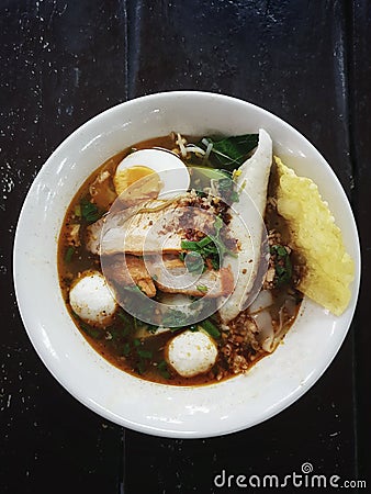 Thai street food : Spicy noddle soup with fish balls, red porks Stock Photo