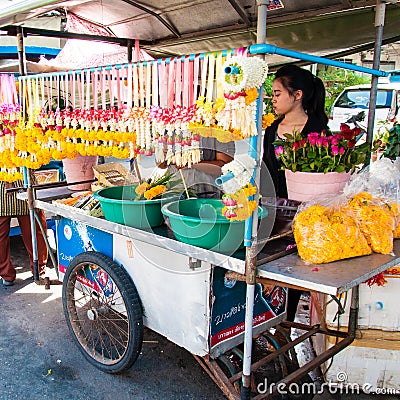 Thai Street vendor of flower garlands in Maeklong, Thailand.Flower garlands are widely used in Editorial Stock Photo