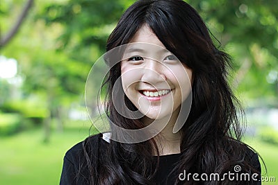 Thai student teen beautiful girl Black Dresses relax and smile. Stock Photo
