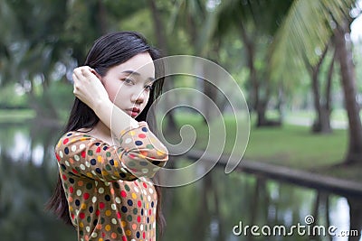 Thai student teen beautiful girl relax and smile in park. Stock Photo