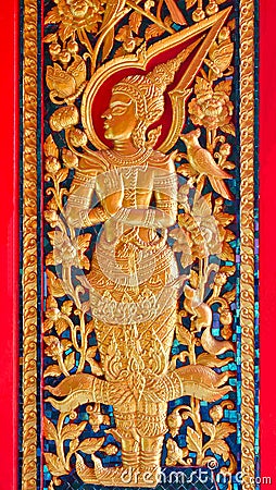 Thai style angel sculpter at temple door in Thailand Stock Photo