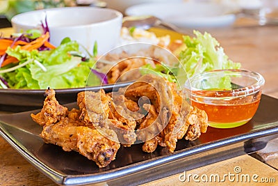 Thai style deep fried chicken wings with sauce and salad Stock Photo