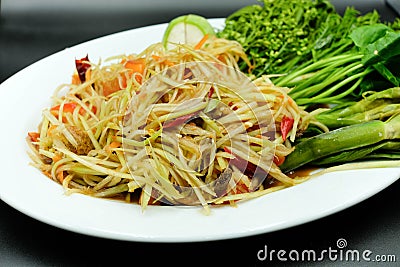 Thai style papaya salad with chilli, tomato and eggplant beside with varity of vegetable using as traditional food and asian hot Stock Photo