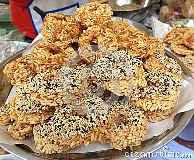 Thai Sweet Crispy Rice Cakes with Cane Sugar Drizzle. Stock Photo