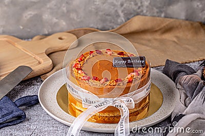 Thai tea layer cake decorated with strawberry and white ribbon for birthday cake. Stock Photo