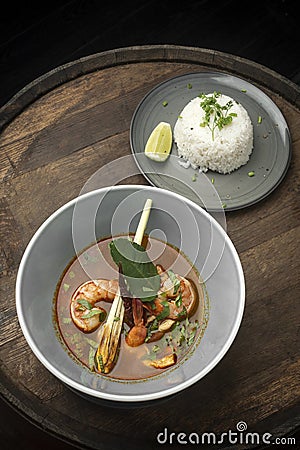 Thai tom yam kung spicy soup with prawns on wood table Stock Photo