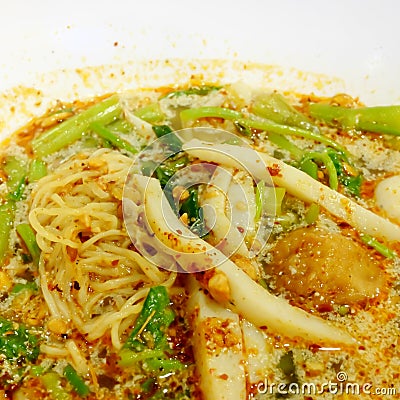 Thai Tom Yum spicy egg noodle soup with fish ball Stock Photo