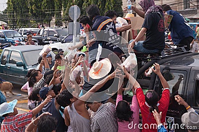 Thai volunteer giving some food bread and water Editorial Stock Photo