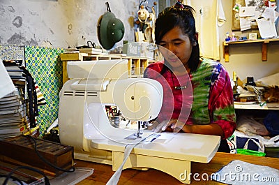 Thai Woman Sewing Machine in Night time Stock Photo