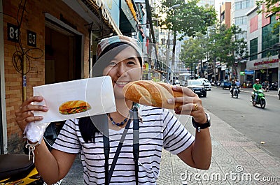 Thai woman show french loaf or baguette sandwich Stock Photo