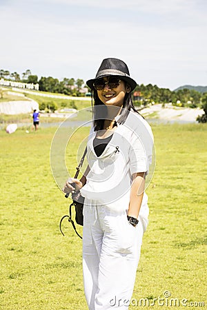 Thai woman travel and posing for take photo on grass field Chang Hua Man Royal Initiative and Agricultural Project Stock Photo