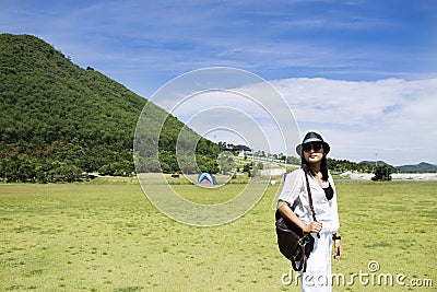 Thai woman travel and posing for take photo on grass field Chang Hua Man Royal Initiative and Agricultural Project Stock Photo
