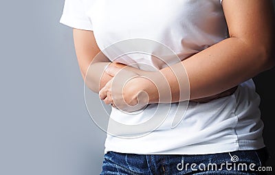 Thai women suffering with severe stomach pain, Stomach ache or menstrual pain Stock Photo