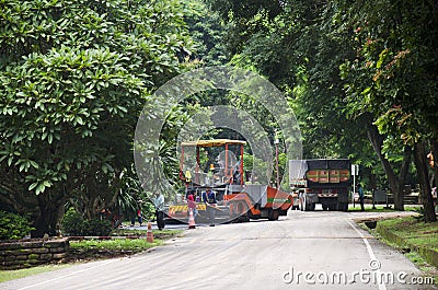 Thai workers working with heavy machinery construction site repair surface of road Editorial Stock Photo