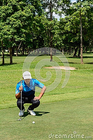 Thai young golf player in action among practice time before enter in golf tournament at Chiang rai ,Thailand Editorial Stock Photo