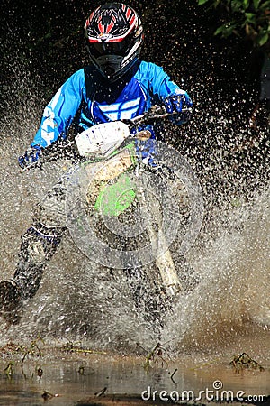 Motocross men, Enduro ride through water splashing in canals, Editorial Stock Photo