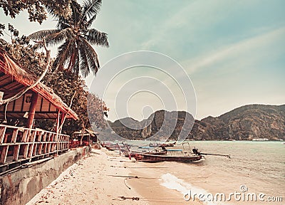 Thailand autumn beach pier: boats at ocean coast waterfront. Water transport at mountain Asia island Stock Photo