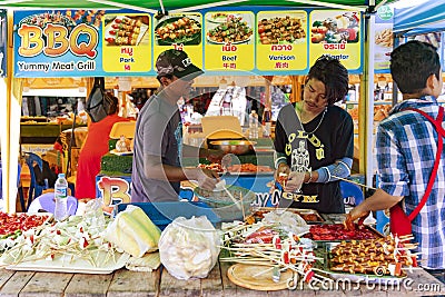 A snack vendor prepares food for sale near Patong beach in Phuket Editorial Stock Photo