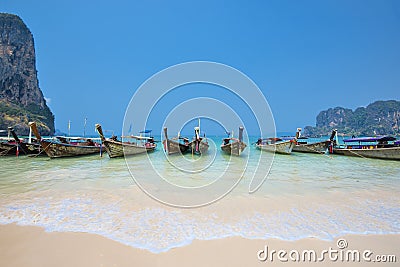 Thailand - May 5, 2016 : Long tail boats wait for tourists at Railay Beach West, Krabi, Thailand Editorial Stock Photo