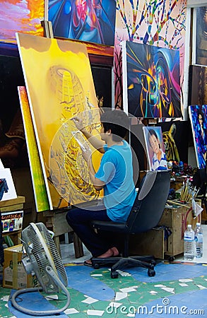 Thailand: painter paints studio yellow Editorial Stock Photo