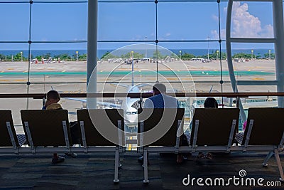 Family, man and kids together sitting and waiting in airport for departure Editorial Stock Photo