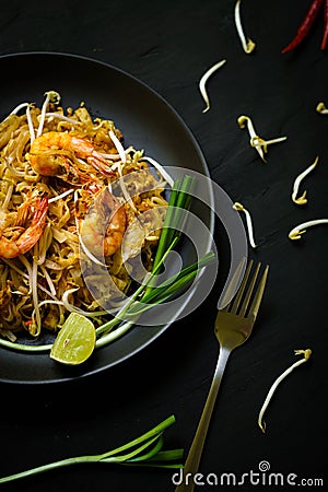 Thailand traditional cuisine, Pad thai, dried noodle, fried noodles, shrimp and seafood, street food, dark food photography Stock Photo