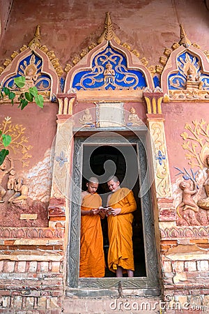 Thailand Two novices are standing reading books together in the Editorial Stock Photo