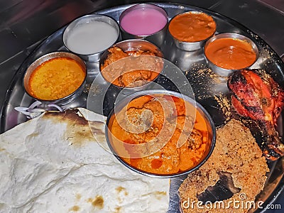 A Thali from kolhapur Maharashtra Indian traditional food with red and white gravies to be served with meat Stock Photo