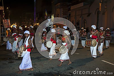 Thammattam Players left and Davul Players right perform through the streets of Kandy during the Esala Perahara in Sri Lanka. Editorial Stock Photo