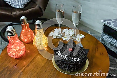 thank you chocolate truffle cake decorated with cherry and artificial light at coffee table Stock Photo