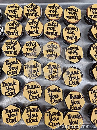 Thank you dad writing on a yellow colour chocolate decoration on top of a cupcake Stock Photo