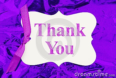 Thank you gift tag over colorful purple glossy paper Stock Photo