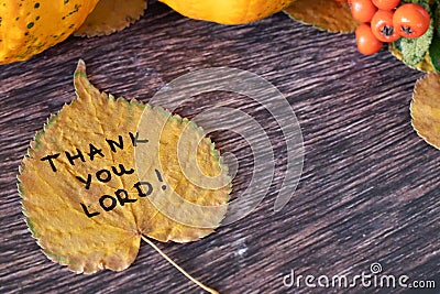 Thank You, LORD, handwritten quote on autumn leaf on wooden background with pumpkin and dry leaves Stock Photo