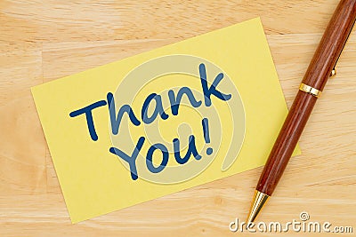 Thank you message on yellow paper index card with pen Stock Photo