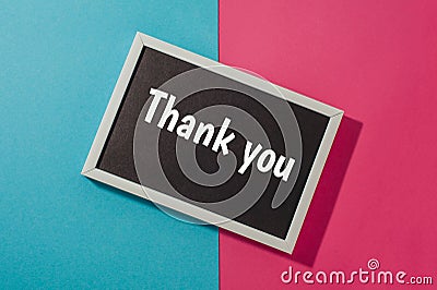 Thank you - text on chalkboard on blue and pink Stock Photo