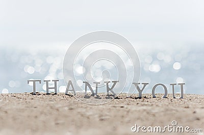 Thank you word drawn on the beach sand Stock Photo