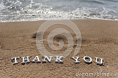 Thank you word drawn on the beach sand Stock Photo