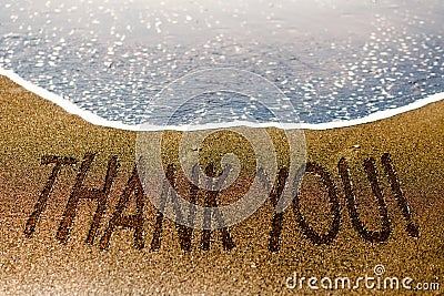 Thank you word drawn on the sand of the beach Stock Photo