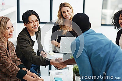 Thank you for your excellent contributions. a colleagues shaking hands during a brainstorming session at work. Stock Photo