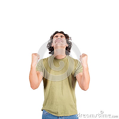 Thankful and pleased young man, long curly hair style, keeps fists tight raised up, eyes closed, contented emotion, isolated on Stock Photo