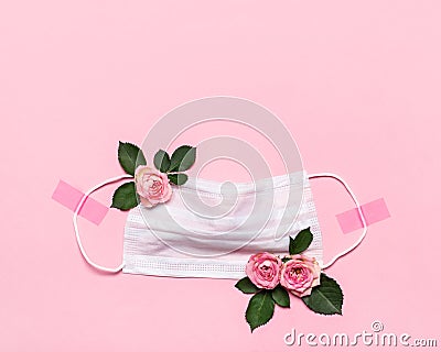 Thanks to Doctor and Nurses concept with medical mask and roses flowers on pink background with copy space Stock Photo