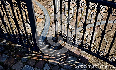 Thanks to its weight, a heavy steel gate hangs in hinges and crosses. to facilitate the cutting of the door, it is possible to pla Stock Photo