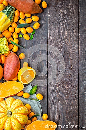 Thanksgiving Autumn Background, Variety of Orange Fruits and Vegetables on Dark Wooden Background with Free Space for Text Stock Photo