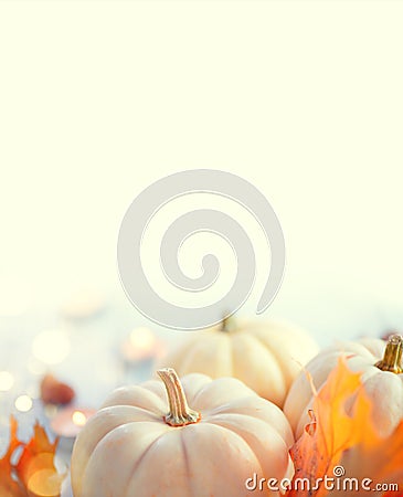 Thanksgiving background. Wooden table, decorated with pumpkins, autumn leaves and candles Stock Photo