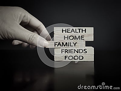 Thanksgiving concept. Health,home,family,friends,food text on wooden blocks with hand background Stock Photo